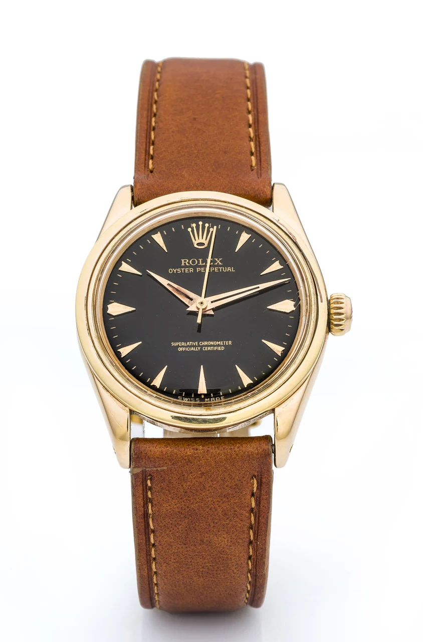 Rolex ROLEX, REF. 6548, OYSTER PERPETUAL A fine and very rare, small, self-winding, 18k pink gold wristwatch with black dial. 31 mm kol saati