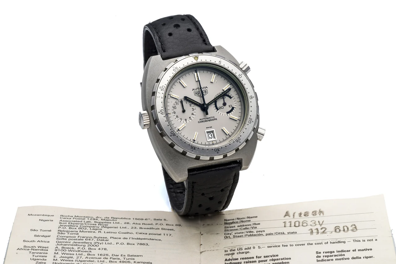 Heuer HEUER, REF. 112.603, AUTAVIA, NEW OLD STOCK A fine and extremely rare, self-winding, grey-coated stainless steel chronograph wristwatch with date. kol saati
