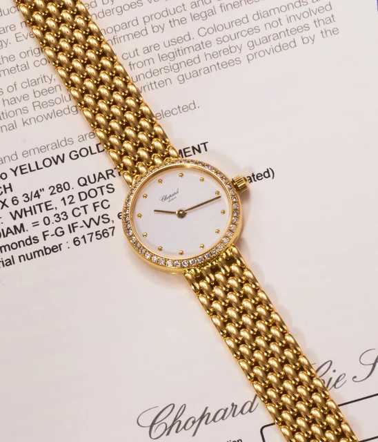 Chopard Ref. 105911-0001-YDBL, white dial, diamond-set bezel, integrated bracelet; 18K yel
